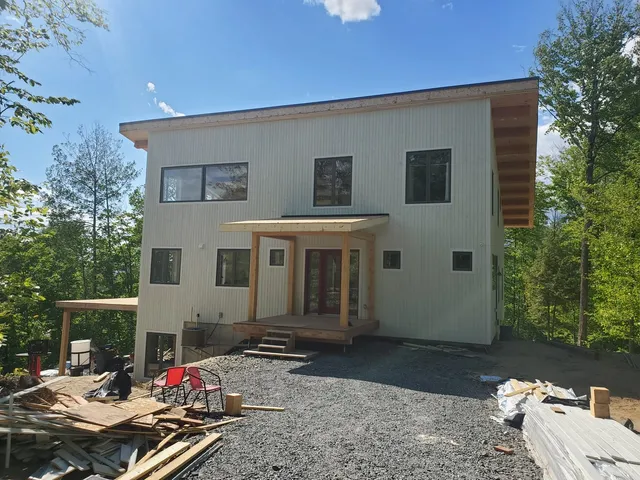 Façade contemporaine avec entrée couverte en bois